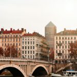 brown concrete building near bridge during daytime