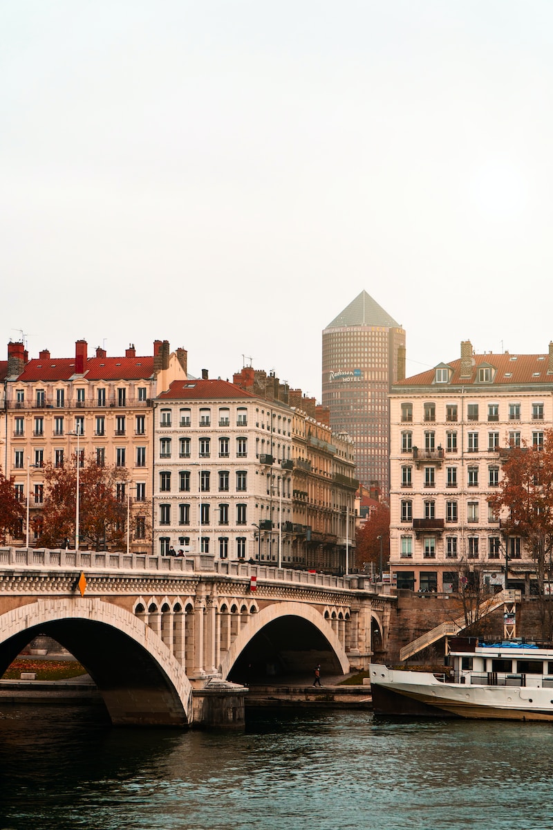 brown concrete building near bridge during daytime