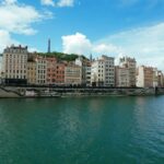 city buildings near body of water under blue sky during daytime