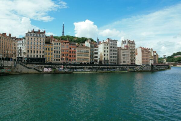 city buildings near body of water under blue sky during daytime